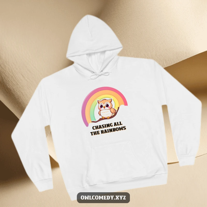 Funny hoodie design showing a delighted, giggling owl having a blast sliding down a shimmering rainbow.