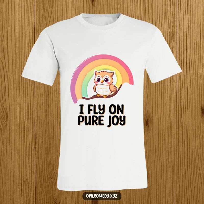 Funny t-shirt graphic of a happy, giggling owl joyfully sliding down a bright, colorful rainbow.