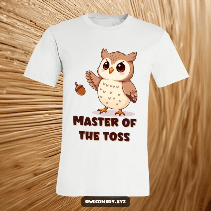 Funny t-shirt print of a playful owl expertly juggling small acorns with its talons, demonstrating a unique and amusing talent.